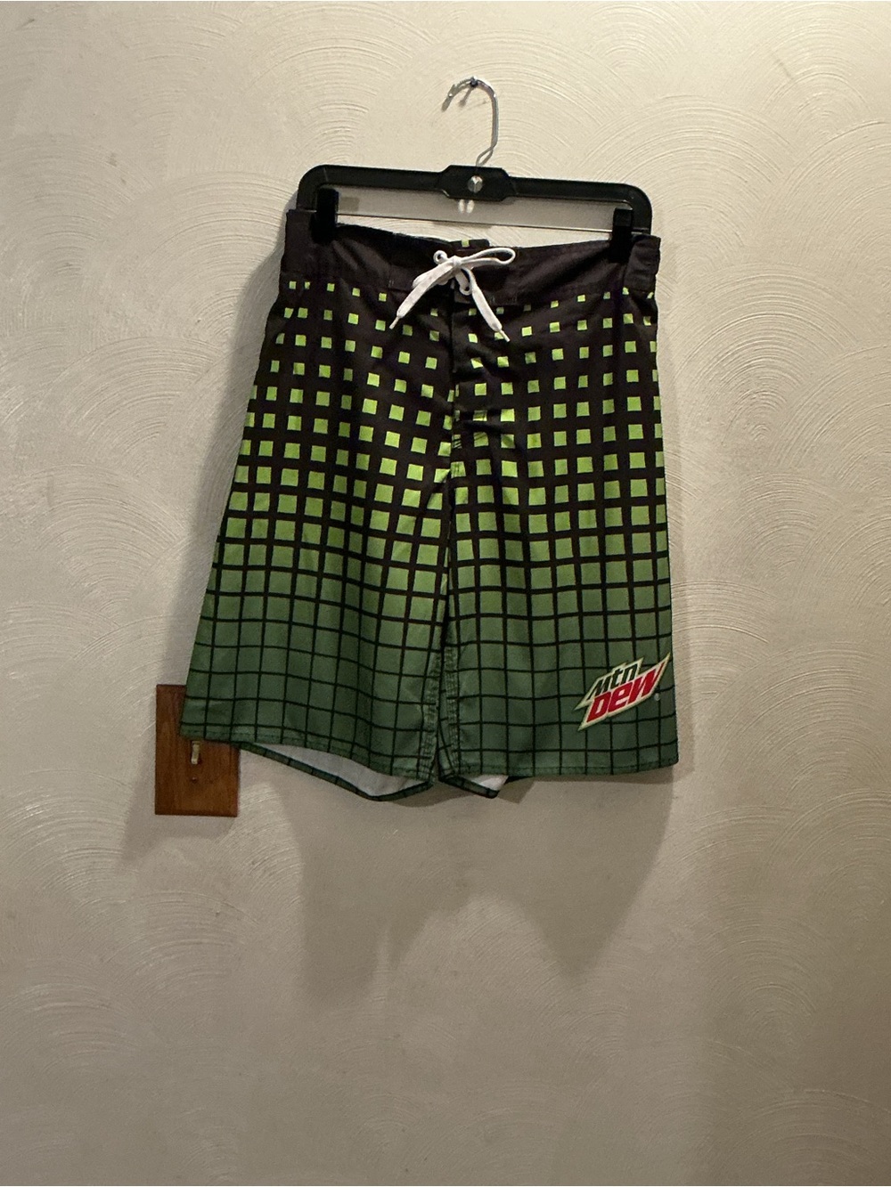 Mtn Dew Black & Green Gradient Grid Board Shorts. Size Medium. Waist: 30” - 34”.